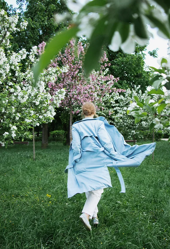 women with blue jacket in garden