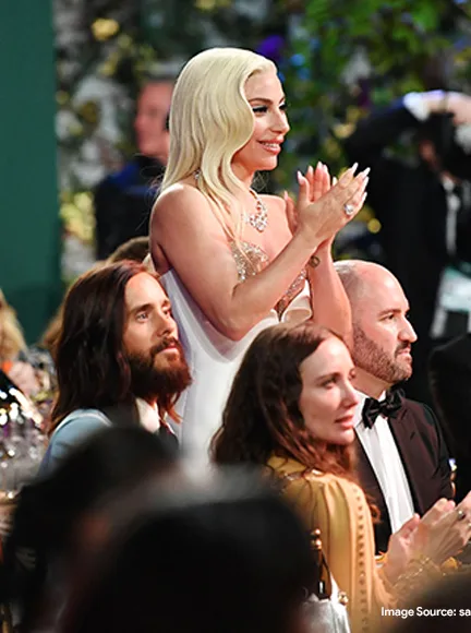 Lady in white dress standing and clapping her hands