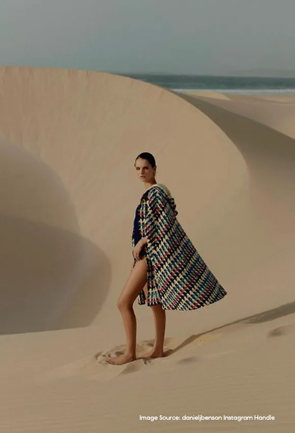 Model standing in desert