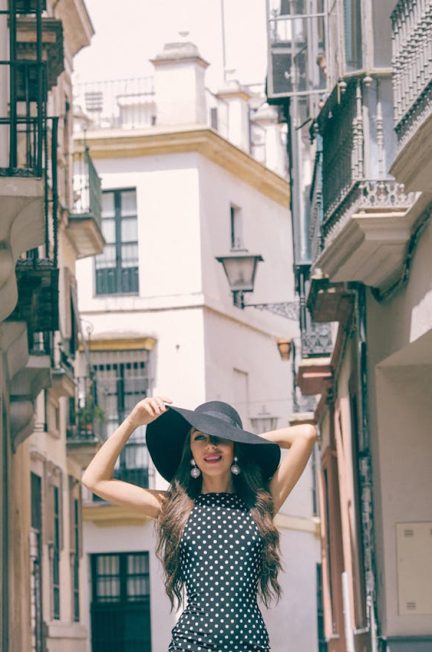 Woman wearing black polka dress and hata