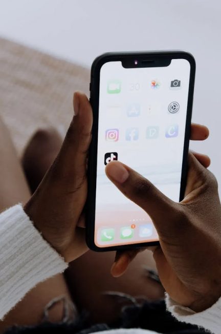 Clicking TikTok app icon on mobile screen