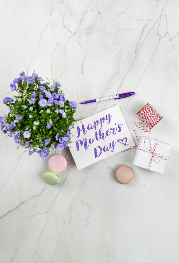 happy mother’s day note surrounded by gifts