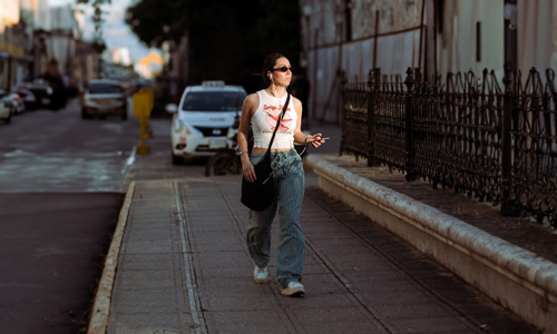 women walking in streets with headphones