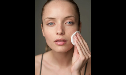 Woman cleaning her face